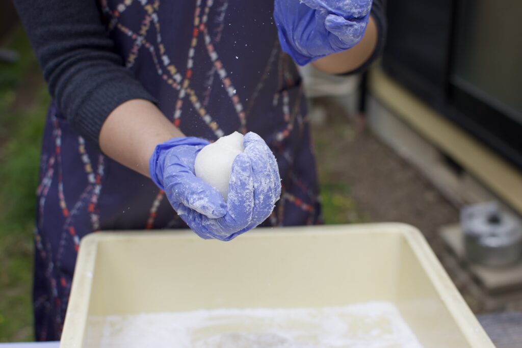 Shaping warm freshly pounded mochi by hand in Kyoto