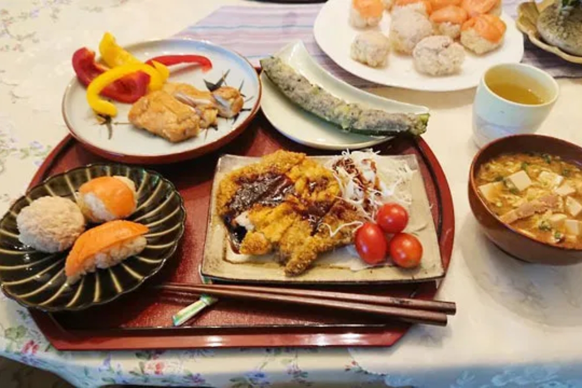 Beautifully plated Japanese home meal with pork cutlet, salmon sushi, and miso soup in Nagoya