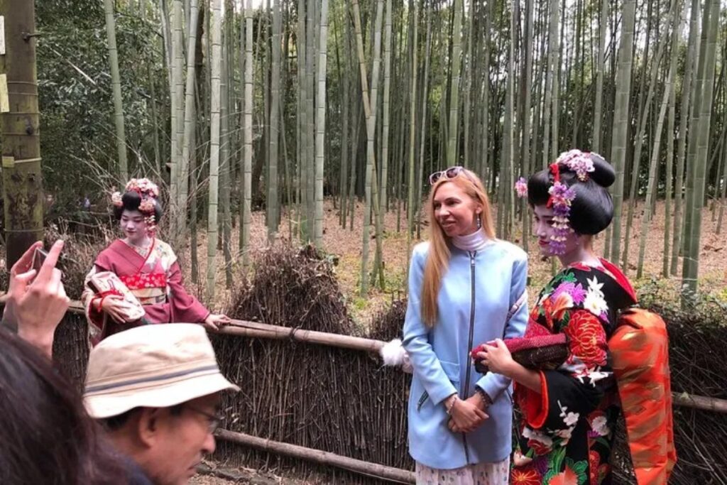 Travelers meeting maiko in Arashiyama bamboo grove during a private full-day Kyoto tour