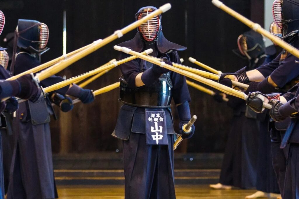Group of kendoka in armor training together at a Kyoto martial arts hall
