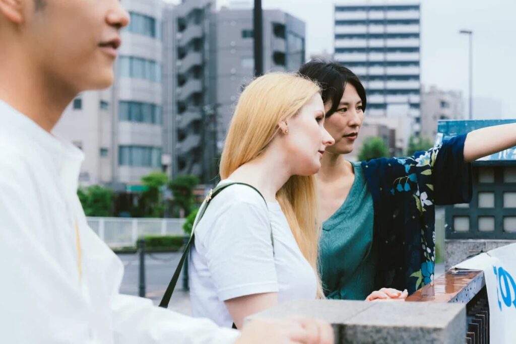 Local guide Manami showing a guest a view in Monzennakacho on a Tokyo temple guided tour