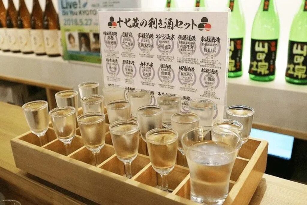 A tasting flight of local sake presented in small glasses on a Kyoto Fushimi food tour.