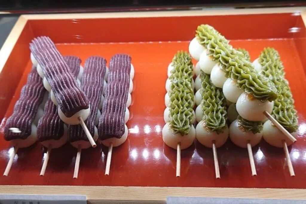 Colorful traditional Japanese sweet dumplings served on wooden skewers.