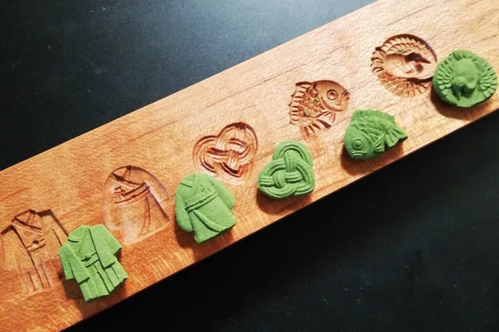 Traditional wooden molds carved by master artisans used to shape sustainable cones at a Uji matcha incense workshop in Kyoto.