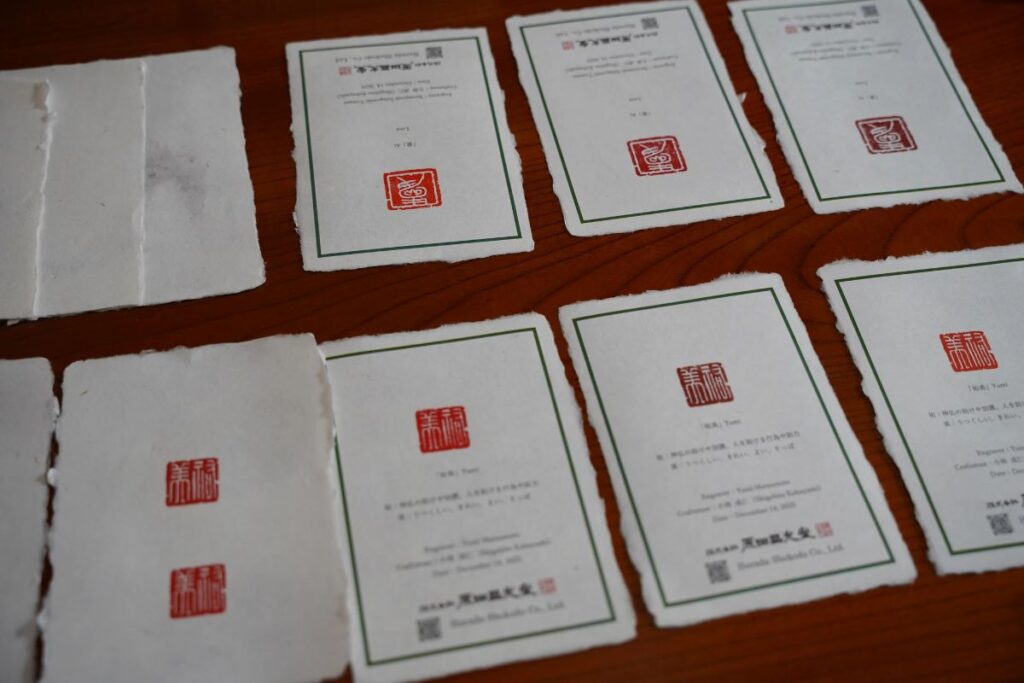 Completed handcrafted washi paper documents stamped with custom hanko seals from an Artisan Experience Yamanashi.