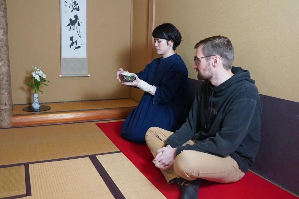 Guests participating in a traditional, peaceful matcha tea ceremony to conclude their luxury Artisan Experience.