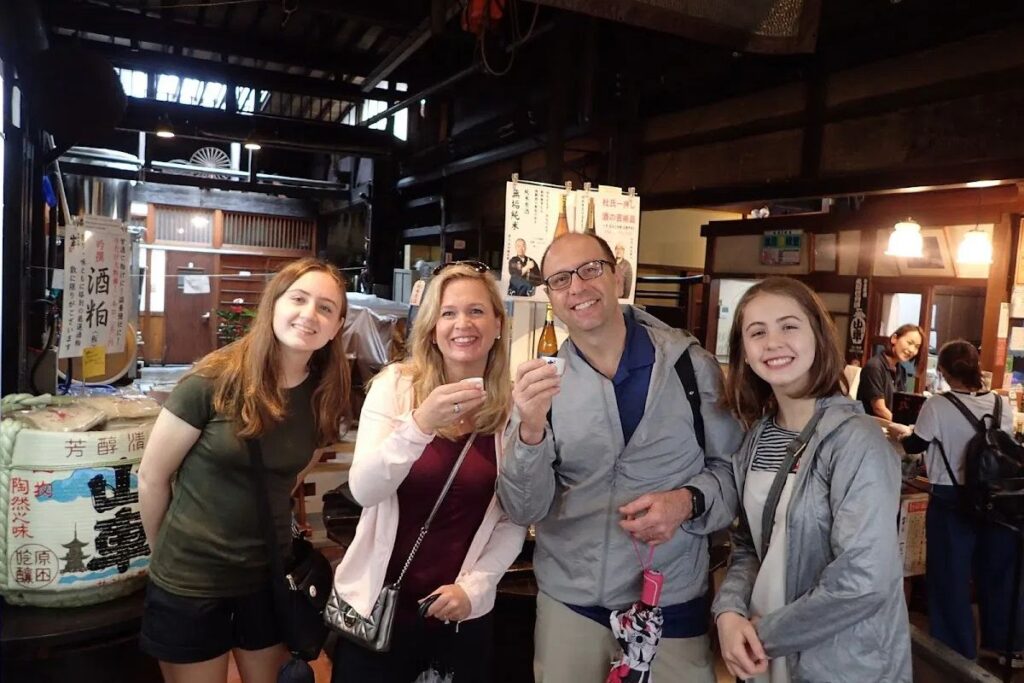 Guests enjoying local delicacies and traditional culture during a guided walking tour in Takayama.