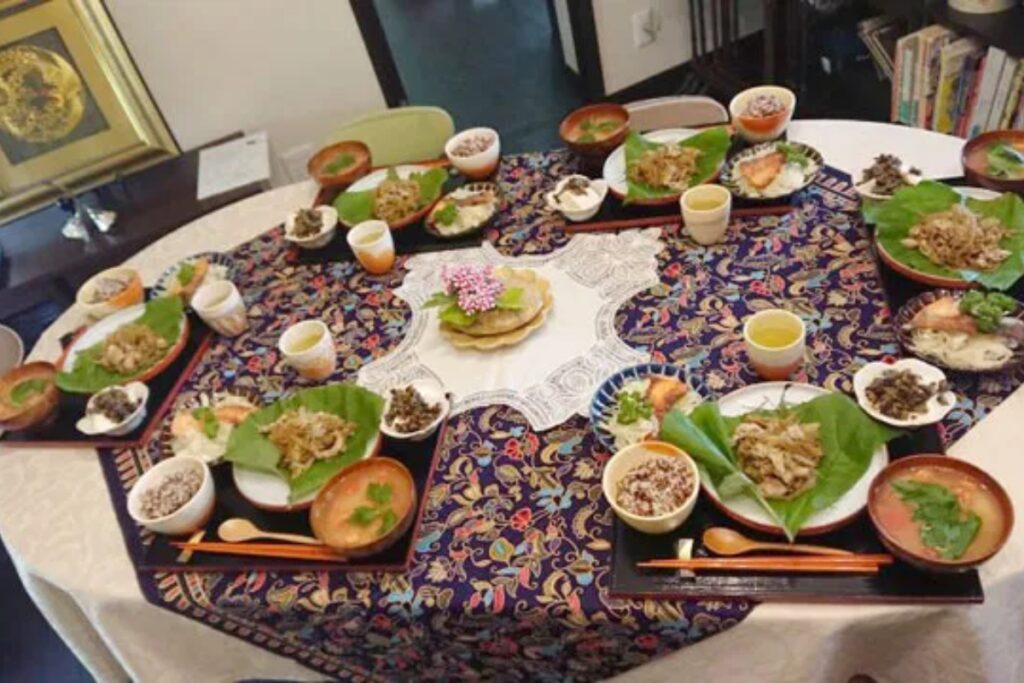 Full spread of homemade Japanese dishes arranged on a round table in a private Nagoya home