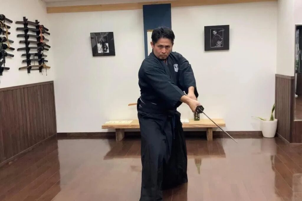 Mugai Ryu master performing an authentic sword draw during a Tokyo Iaido experience demonstration