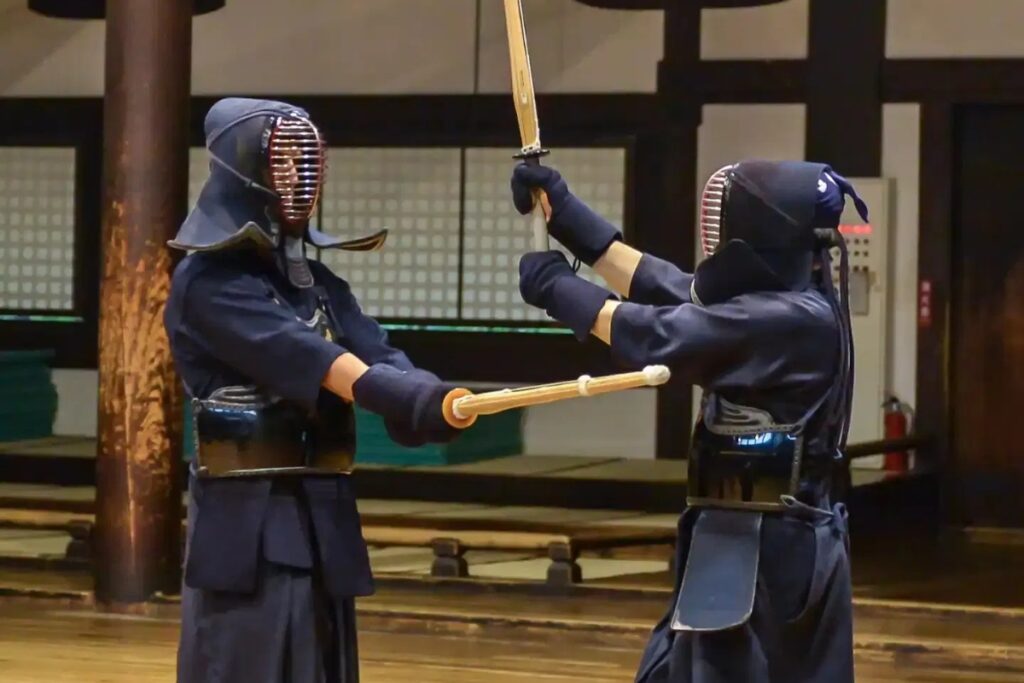 Two kendoka facing off with shinai during a Kyoto Kendo session