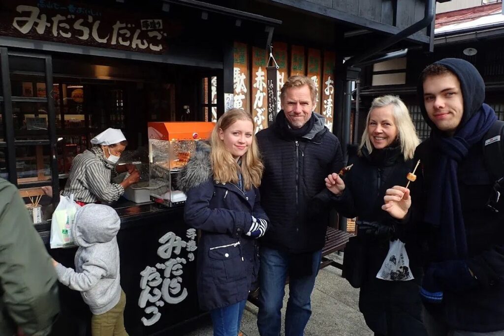 A small private tour group exploring historic neighborhood storefronts with an expert local guide.