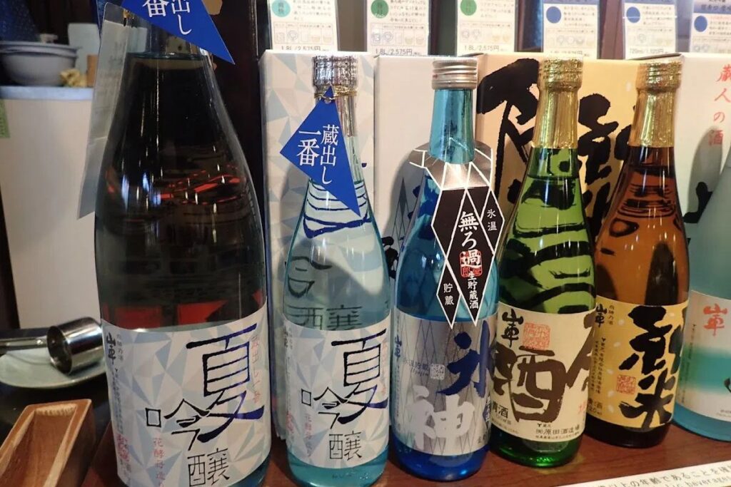 Premium regional Japanese sake bottles on display at a traditional local sake brewery.