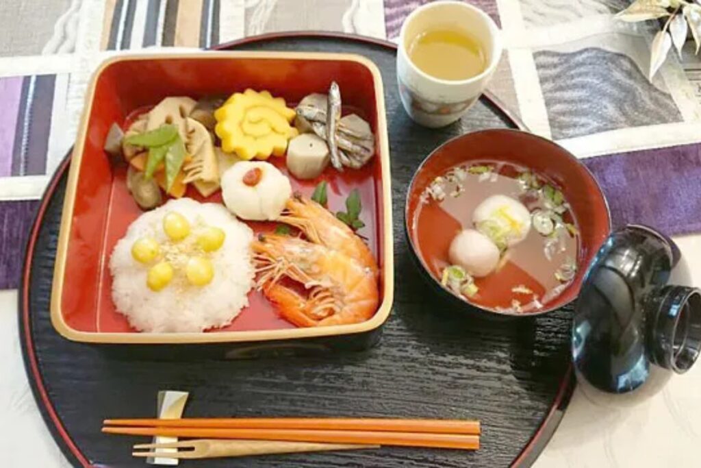 Elegant Japanese meal in a red lacquer box with shrimp and dumpling soup at a Nagoya cooking class