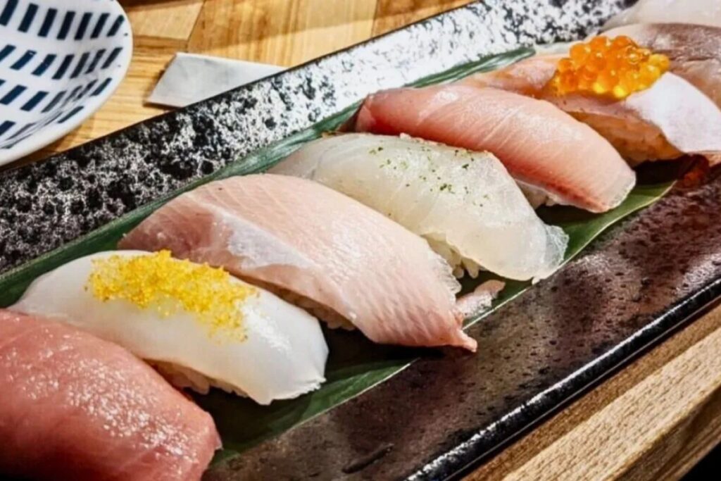 Beautifully arranged nigiri sushi topped with fresh fish and roe at a Tokyo sushi making experience