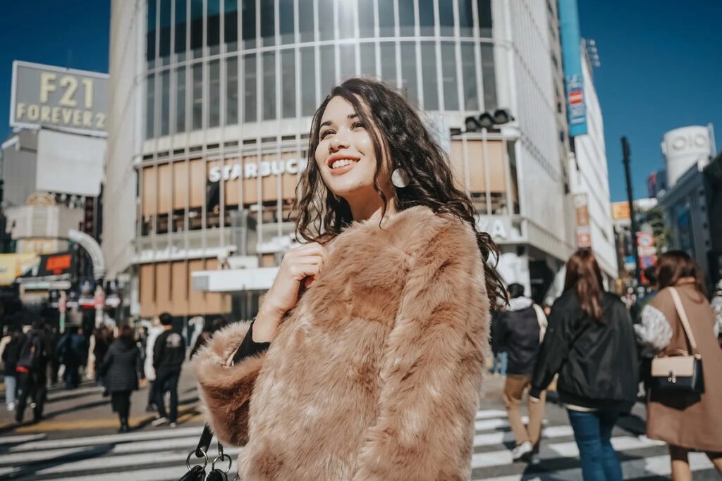 Guest posing in a fur coat at the busy Shibuya crossing during a Tokyo private photographer session