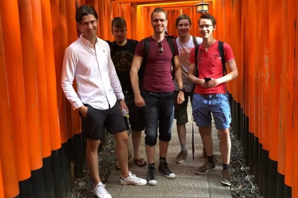Group walking through the vermillion torii gates of Fushimi Inari Shrine on a private full-day Kyoto tour