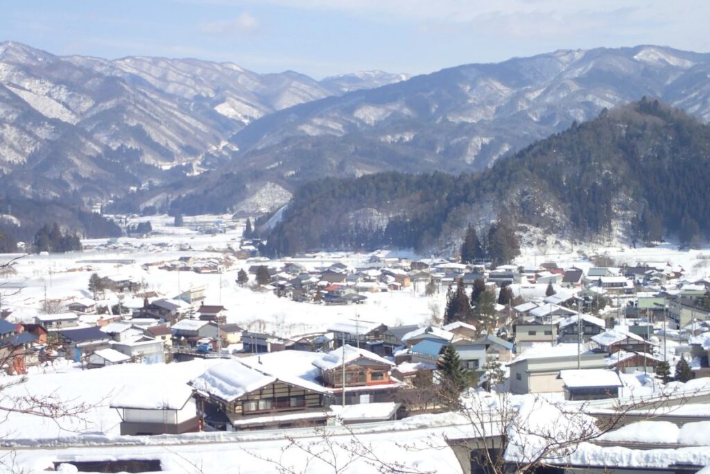 A spectacular winter wonderland view of a snow-covered mountain village and local vistas.