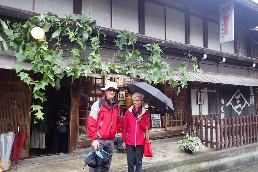 Guests discovering the elegant wooden architecture and traditional charm of a rural small town.