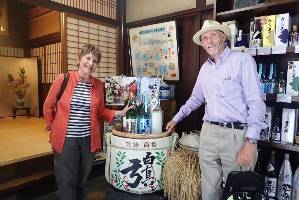 Travelers exploring regional heritage and traditional sake breweries in the Hida region.