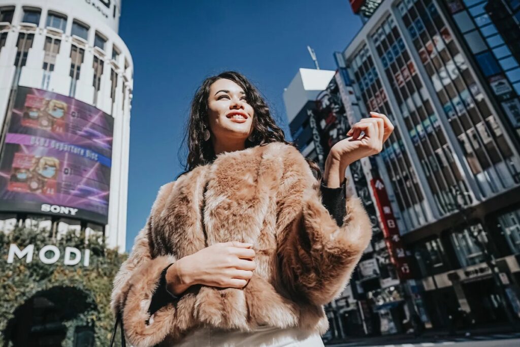 Stylish model photographed against the Shibuya cityscape on a Tokyo personal photoshoot walk