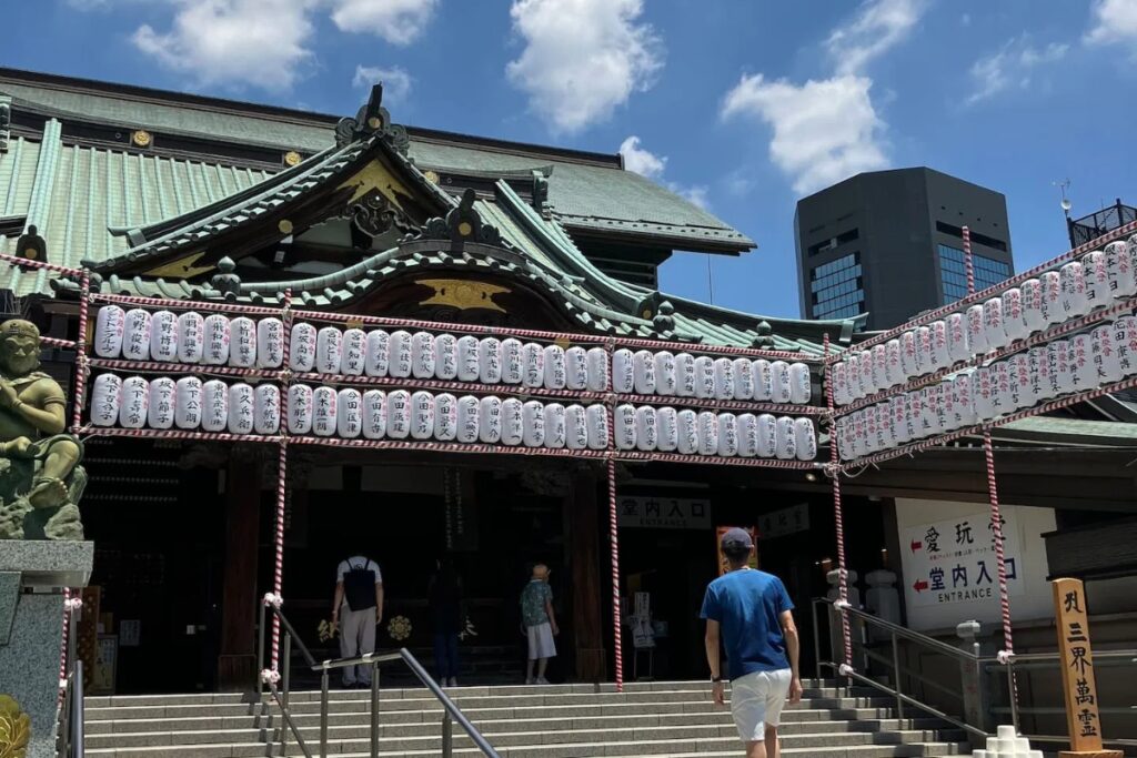 Historic Naritasan Fukagawa Fudōdō Temple hall decorated with rows of white paper lanterns in Tokyo
