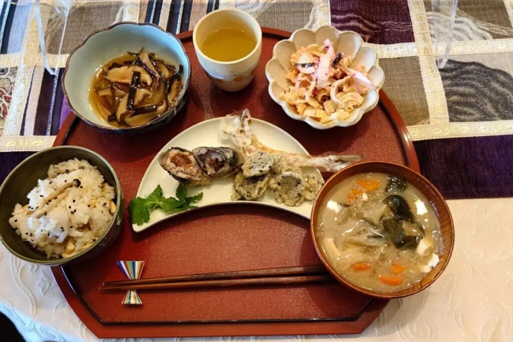 Seasonal Japanese set meal with grilled fish, tempura, and mixed rice from a Nagoya cooking class