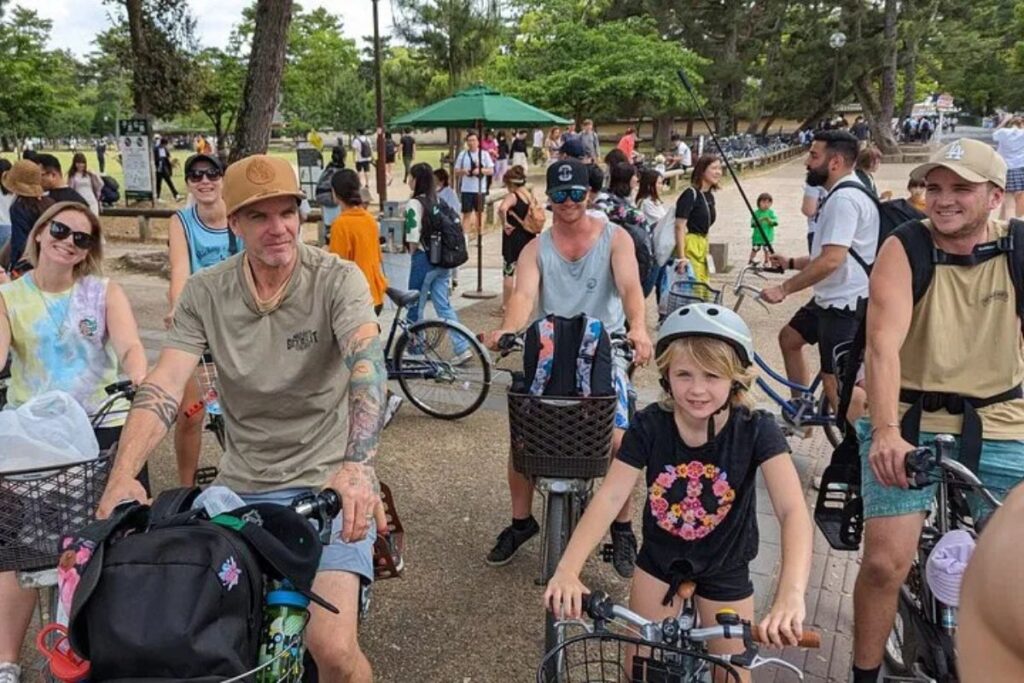 A family riding together through a park pathway during a Nara highlights E-bike tour.
