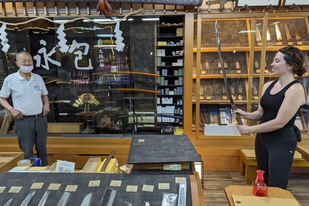 High-quality kitchen blades neatly displayed on wooden shelves inside a historic artisan shop.