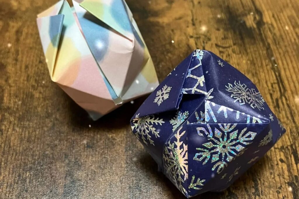 Two highly intricate, complex modular geometric structures crafted from premium patterned sheets during an advanced Tokyo origami private workshop.