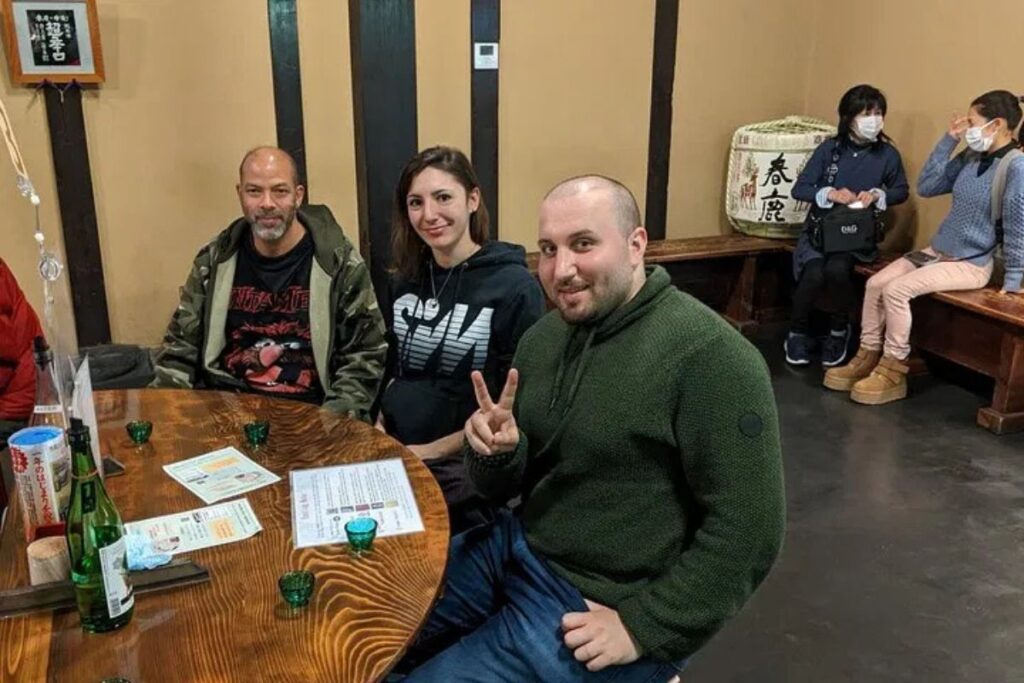 Guests enjoying a traditional sake tasting experience on a Nara food walking tour.