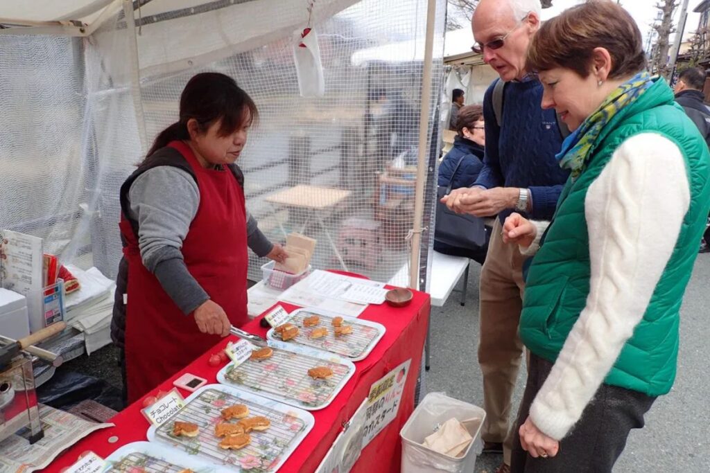Tasting authentic regional street food with a local guide before beginning a Hida cycling journey.