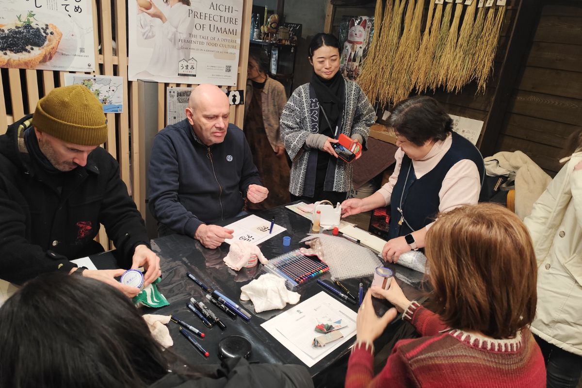 Guests painting and designing their custom bottle templates during the sake label making experience workshop.