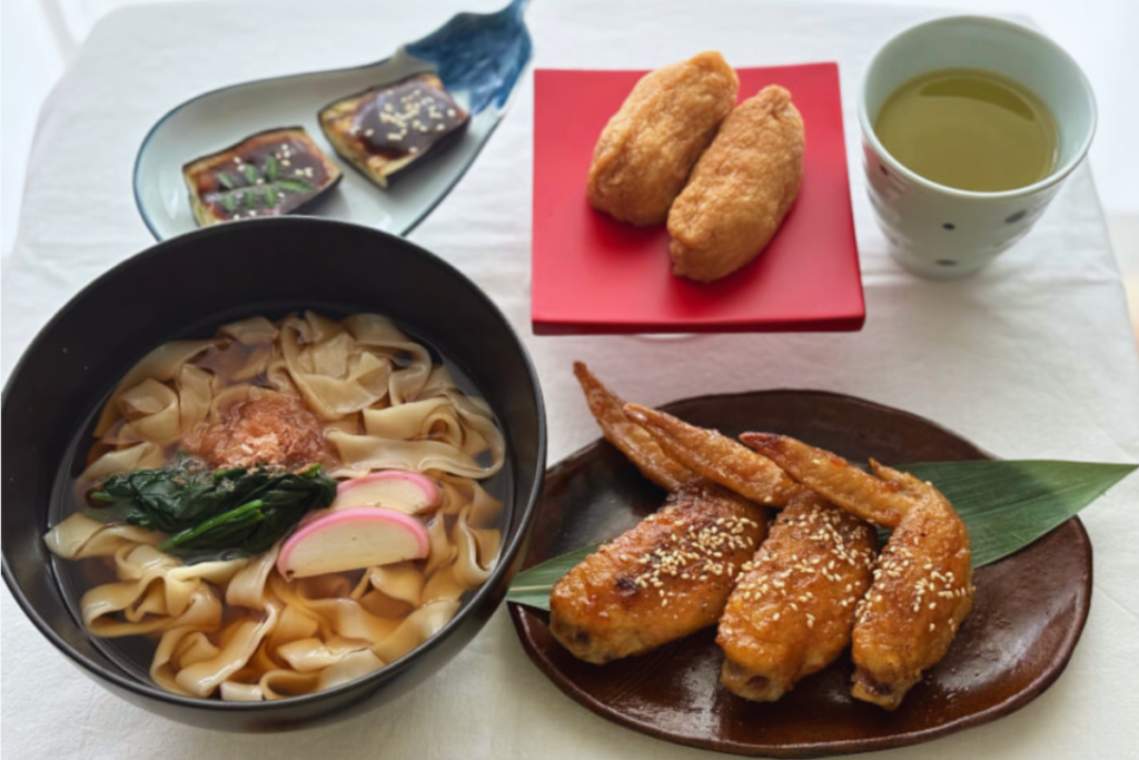 Traditional Nagoya home-cooked dishes including local noodle soup and regional specialties served on traditional Japanese tableware.