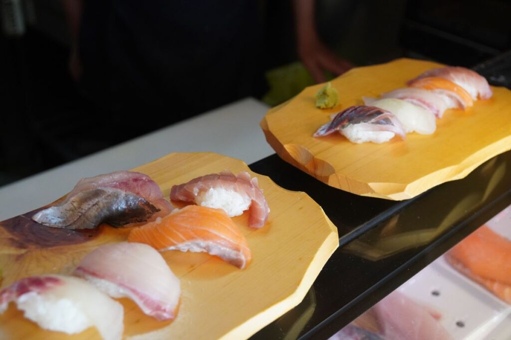 Two beautifully arranged wooden platters loaded with fresh handmade nigiri sushi ready for the tasting session.