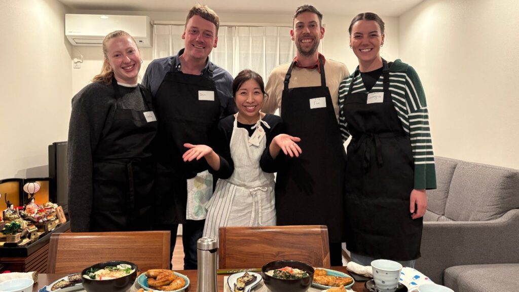 Western travelers enjoying a private Nagoya home cooking class and dining experience with their local Japanese host.