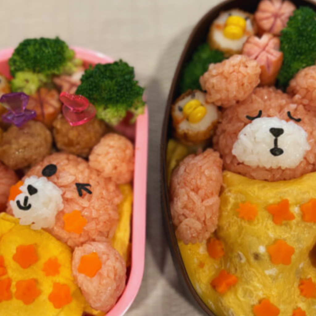 Artfully crafted Japanese character bento lunch box featuring bear-shaped rice and sculpted ingredients prepared in a Nagoya cooking class.