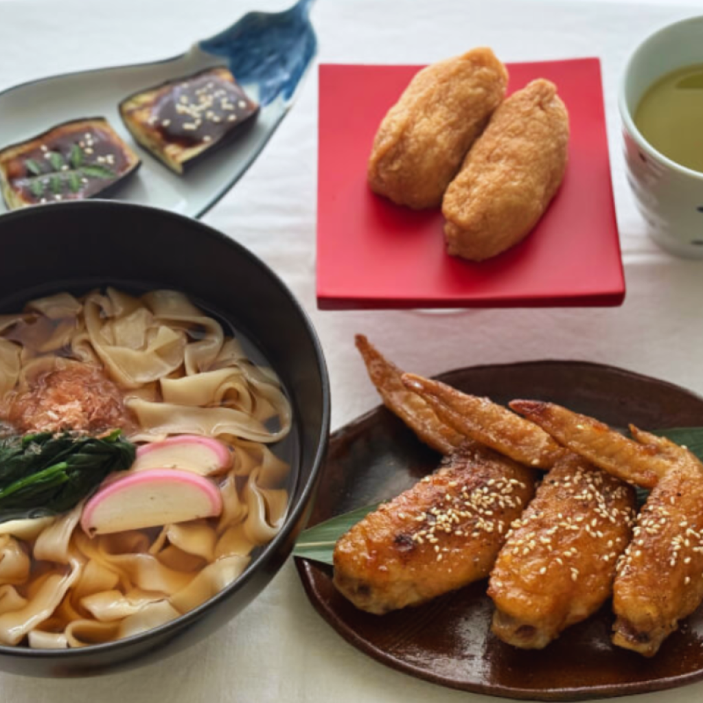 Traditional Nagoya home-cooked dishes including local noodle soup and regional specialties served on traditional Japanese tableware.